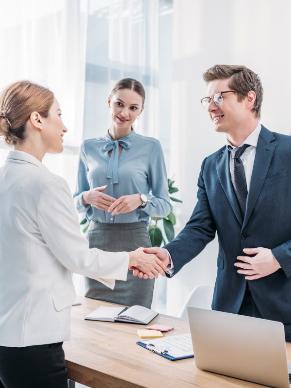cheerful-recruiter-shaking-hands-with-woman-near-colleague-in-office.jpg cheerful-recruiter-shaking-hands-with-woman-near-colleague-in-office.jpg