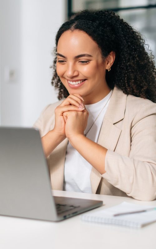 Happy brazilian or hispanic curly haired business woman, company ceo, recruitment manager, sitting Happy brazilian or hispanic curly haired business woman, company ceo, recruitment manager, sitting